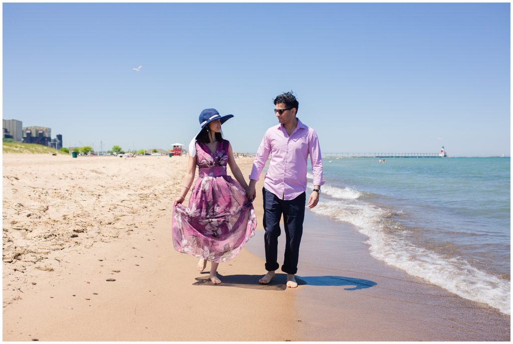 Engaged-couples-walking-by-beach